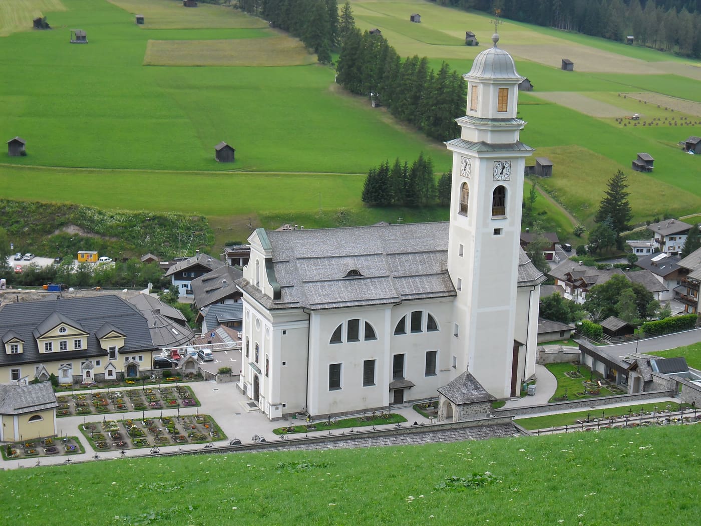 Parish Church St. Peter and Paul with cemetery chapel and cemetery in Sexten